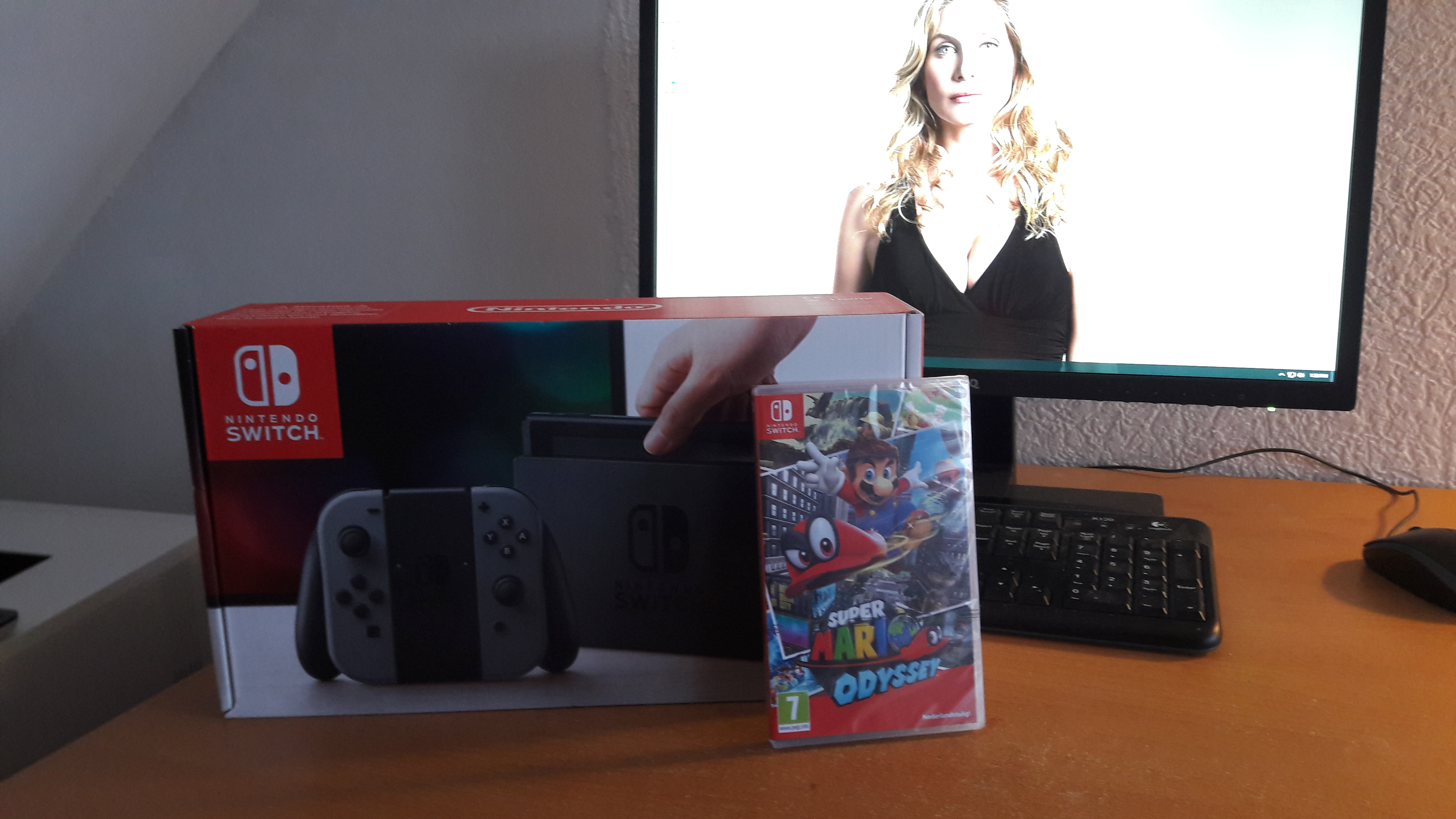 Nintendo Switch box and Super Mario Odyssey with Elizabeth Mitchell