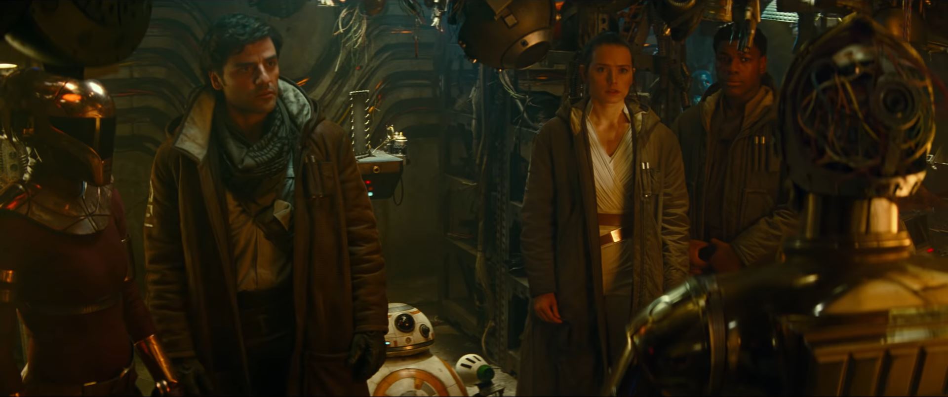 Poe Rey Finn and BB-8 watch C3PO in The Rise of Skywalker